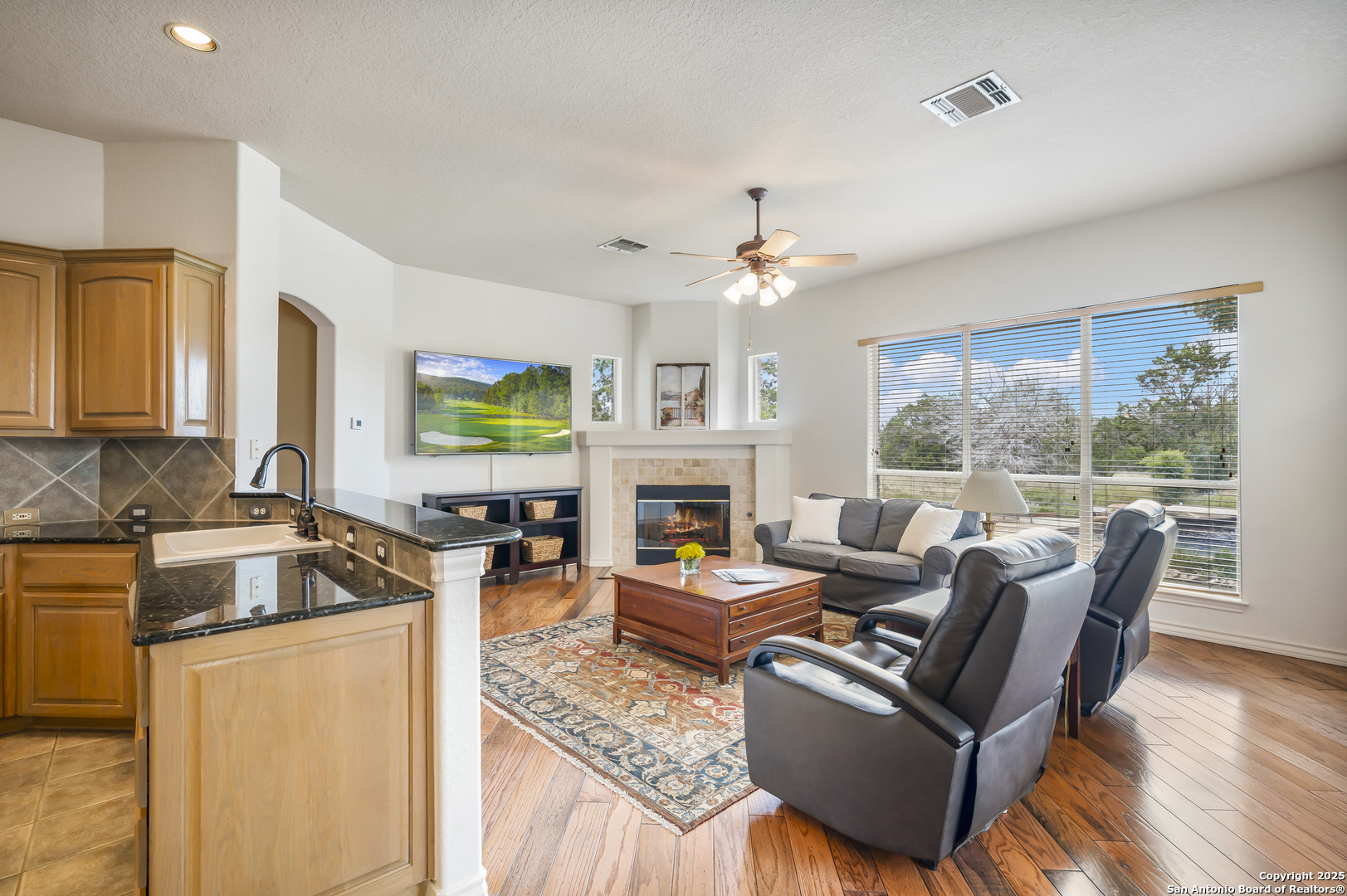 221 Park Ridge Boerne, TX 78006 - Photo 11 of 35 a living room with furniture a fireplace and a flat screen tv