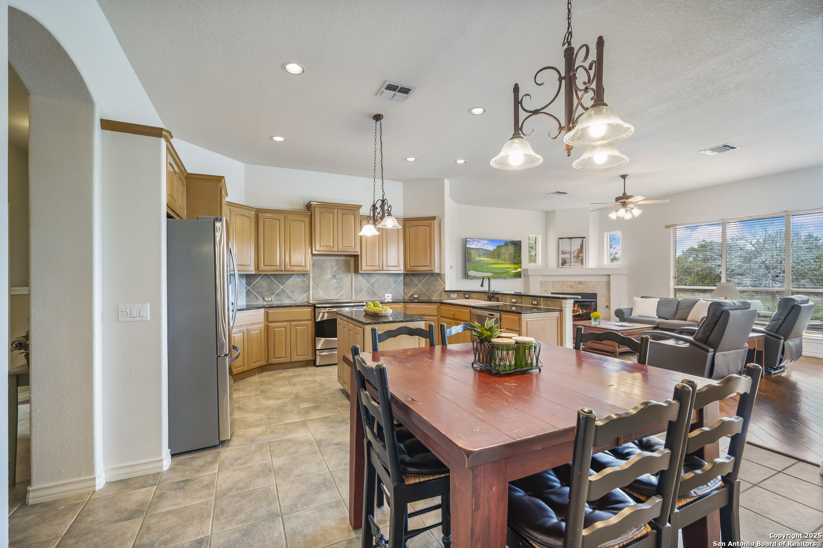 221 Park Ridge Boerne, TX 78006 - Photo 15 of 35 a kitchen with stainless steel appliances granite countertop a stove a refrigerator a kitchen island a table and chairs