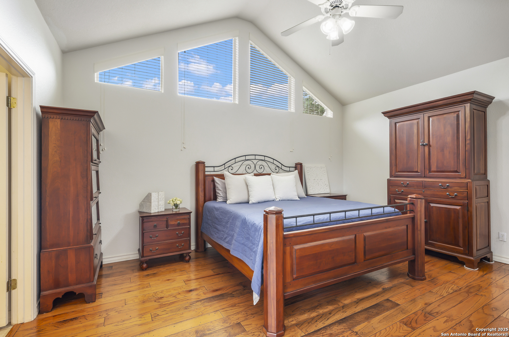 221 Park Ridge Boerne, TX 78006 - Photo 17 of 35 a bedroom with a bed and a chandelier