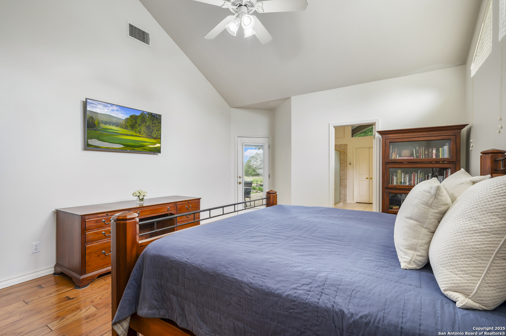 221 Park Ridge Boerne, TX 78006 - Photo 18 of 35 a bed room with a bed and a chandelier