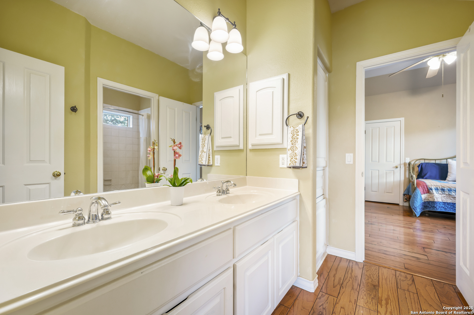 221 Park Ridge Boerne, TX 78006 - Photo 23 of 35 a en suite bathroom with a double vanity sink and a mirror
