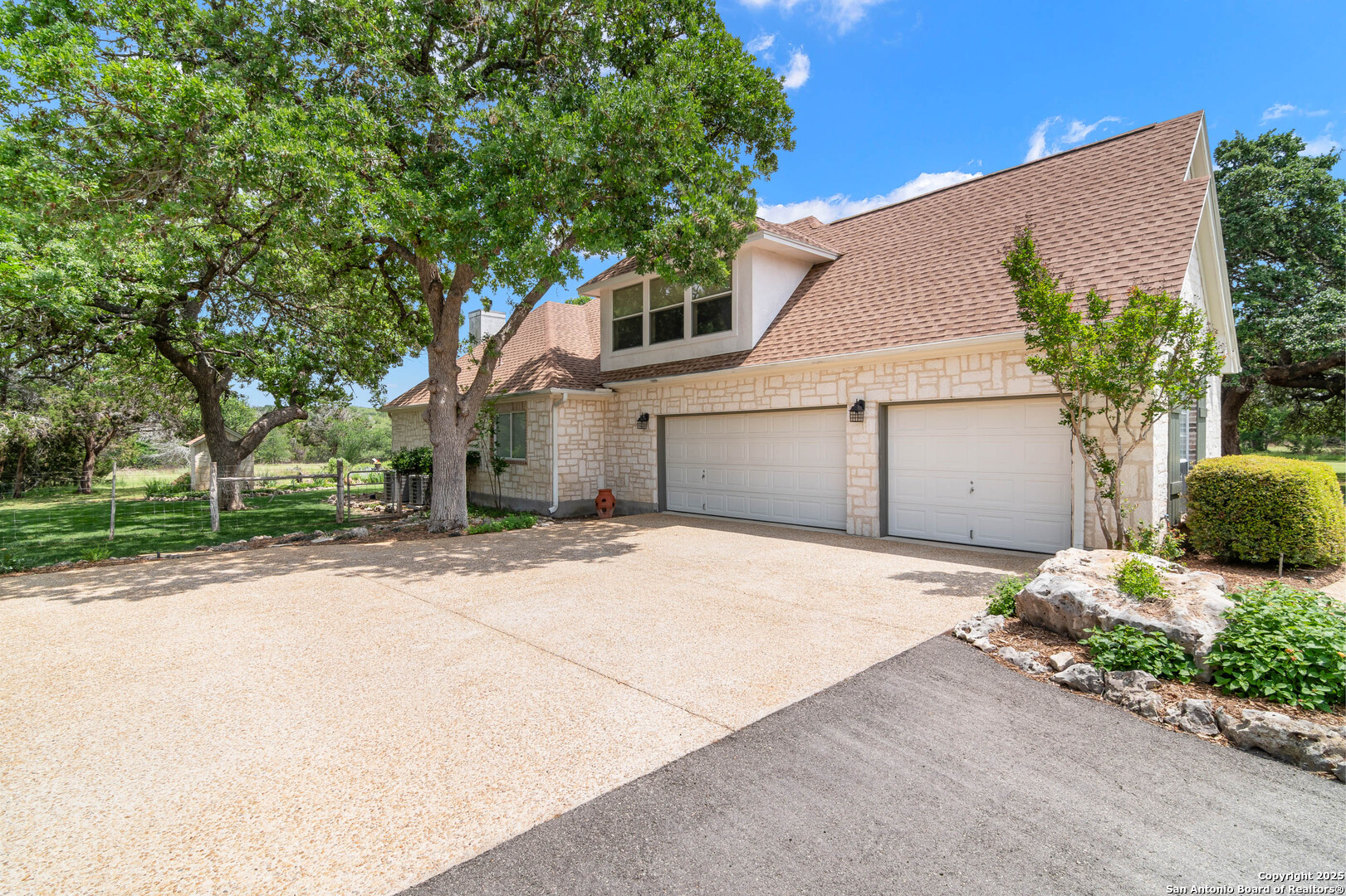 221 Park Ridge Boerne, TX 78006 - Photo 34 of 35 a front view of a house with a yard and a garage