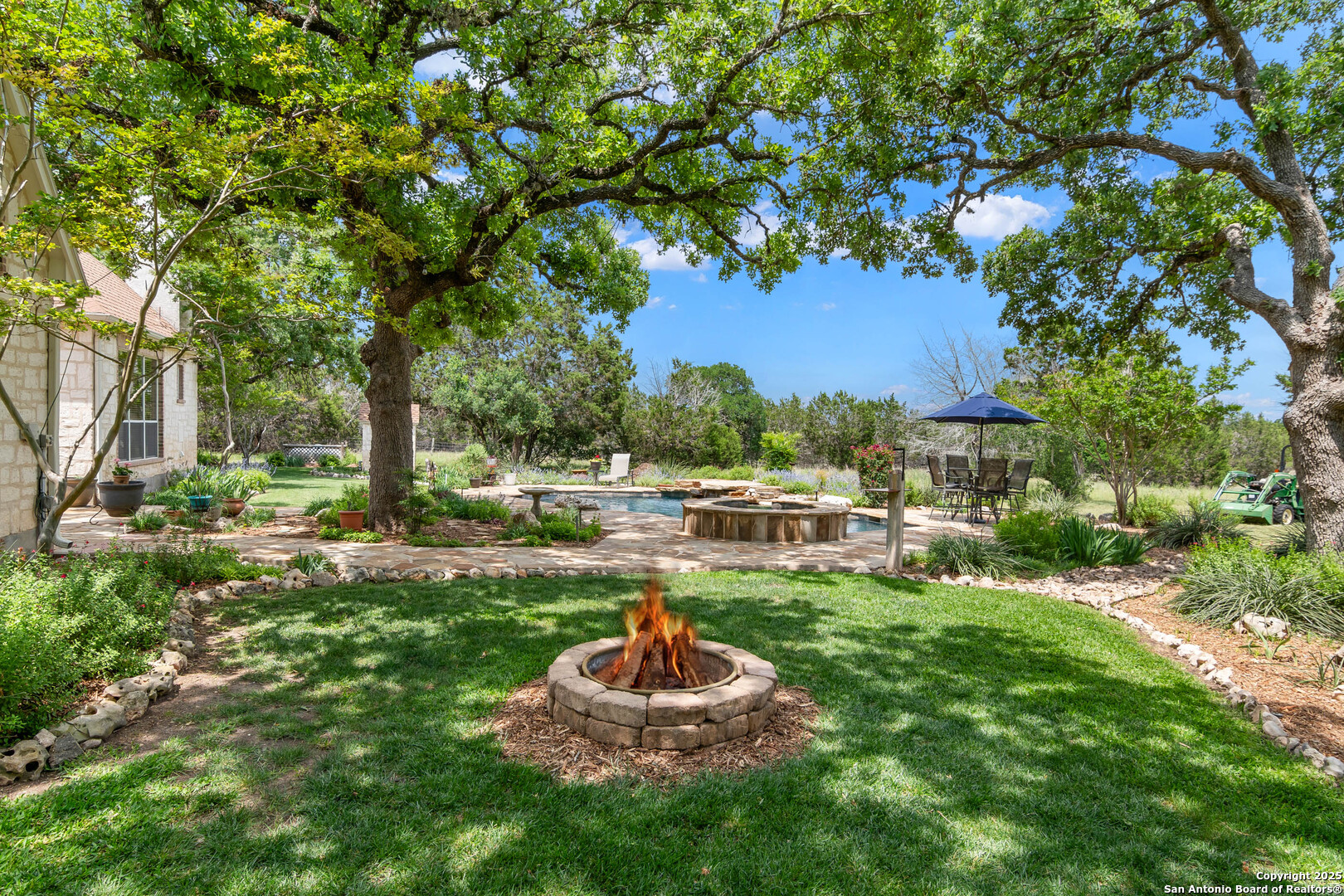 221 Park Ridge Boerne, TX 78006 - Photo 5 of 35 a backyard of a house with table and chairs
