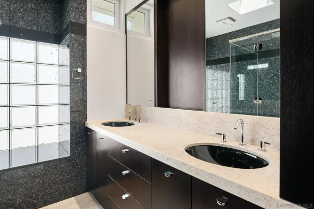 a kitchen with granite countertop a sink and cabinets