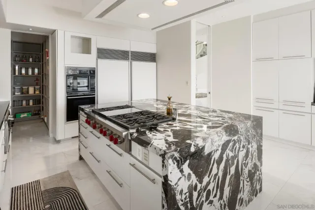 a dining room with furniture and a floor to ceiling window
