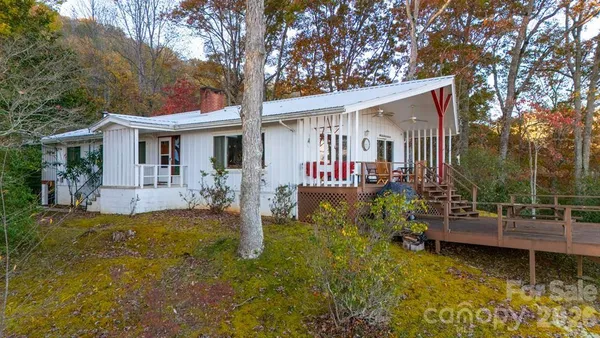a view of a house with backyard and sitting area