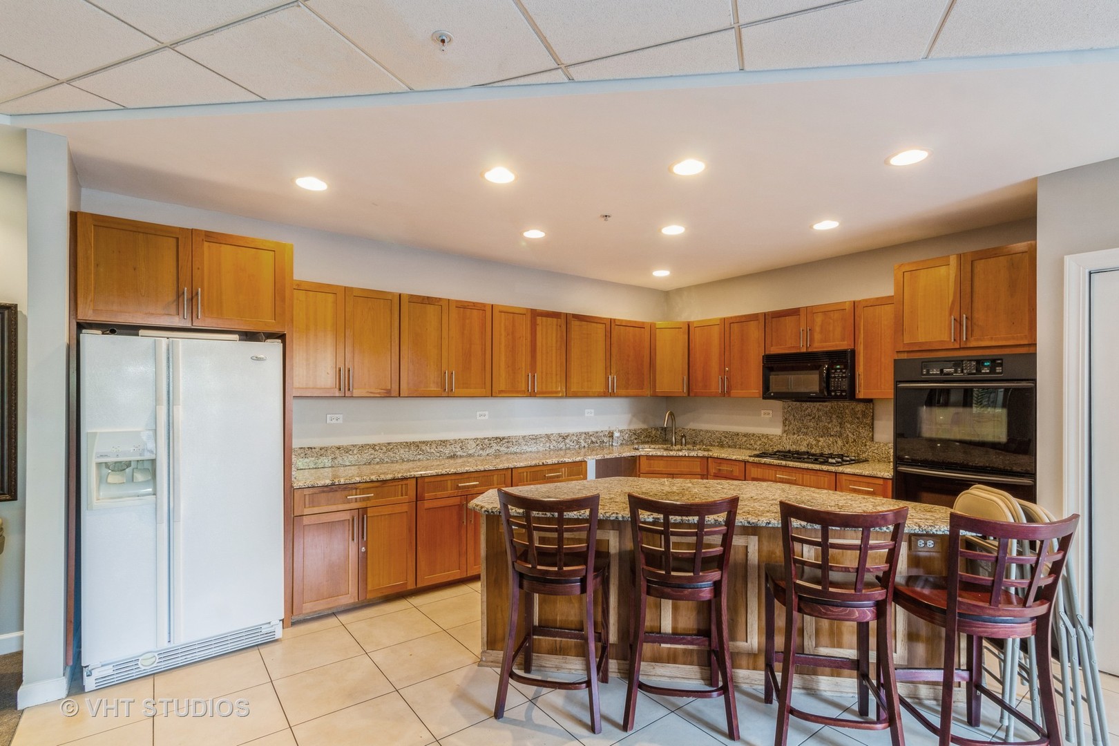 1 Renaissance Place, Unit 1117 Palatine, IL 60067 - Photo 16 of 20 a kitchen with stainless steel appliances granite countertop a table chairs sink and refrigerator