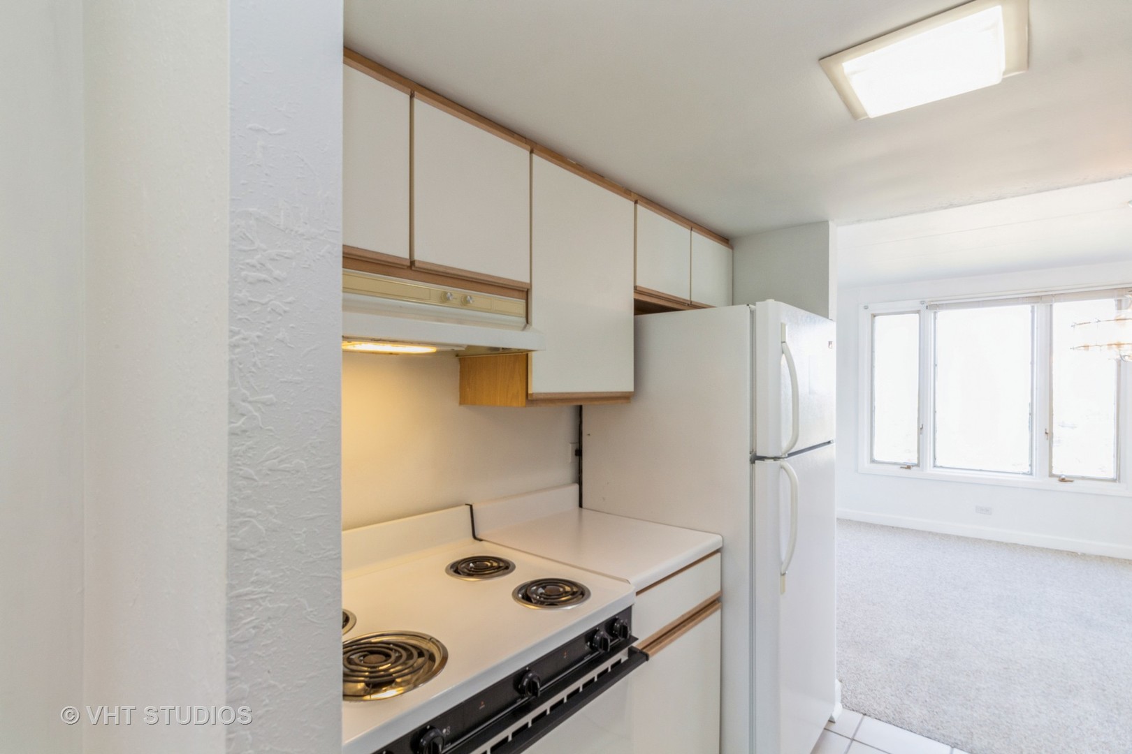 1 Renaissance Place, Unit 1117 Palatine, IL 60067 - Photo 4 of 20 a kitchen with a sink cabinets and a refrigerator