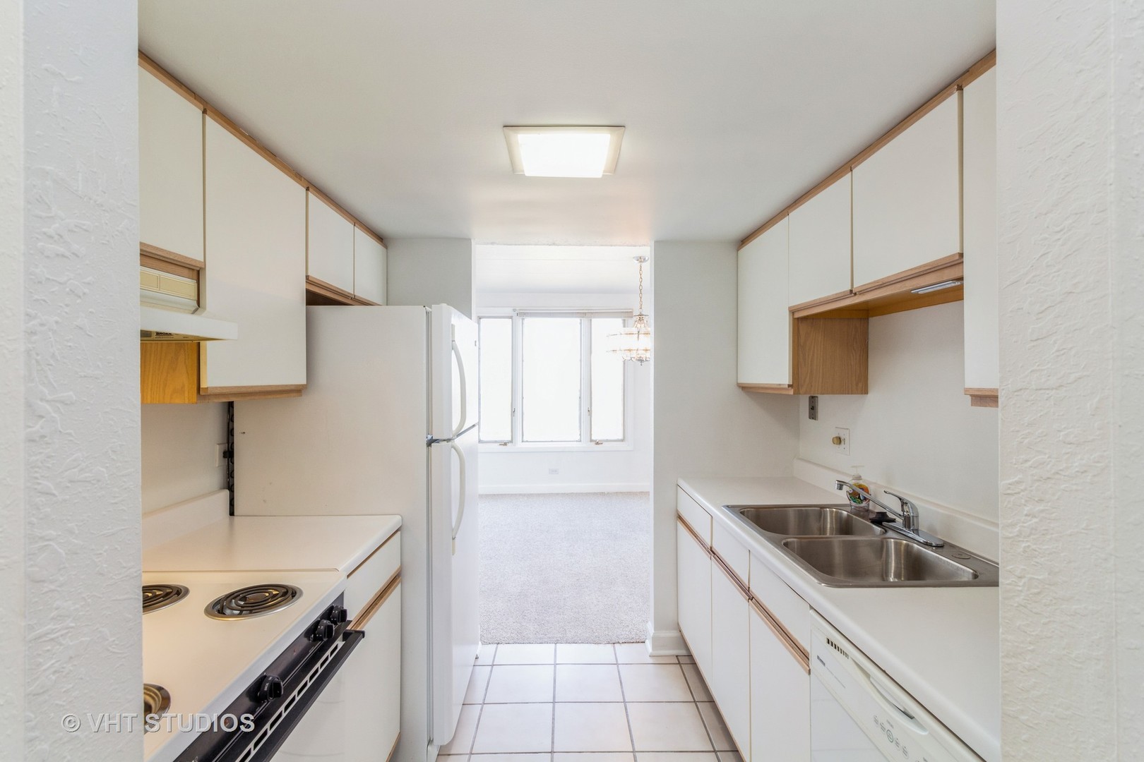 1 Renaissance Place, Unit 1117 Palatine, IL 60067 - Photo 5 of 20 a kitchen with a sink stove top oven and refrigerator