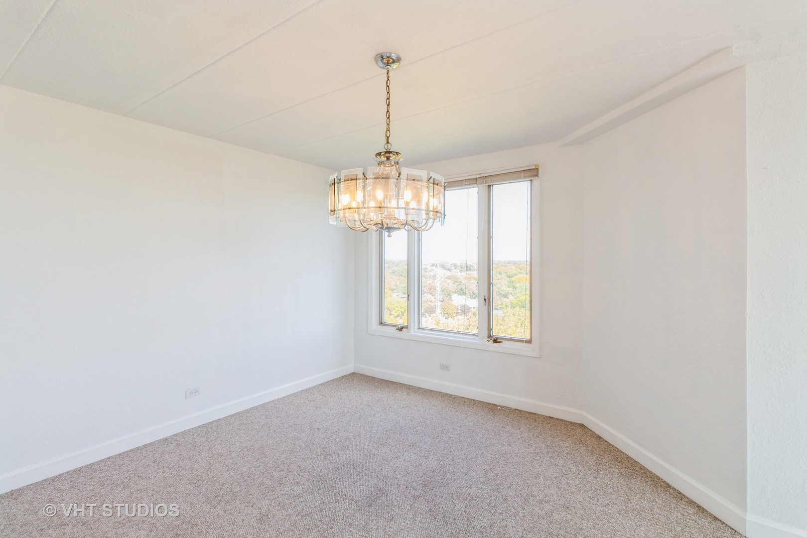 1 Renaissance Place, Unit 1117 Palatine, IL 60067 - Photo 6 of 20 an empty room with windows and chandelier fan