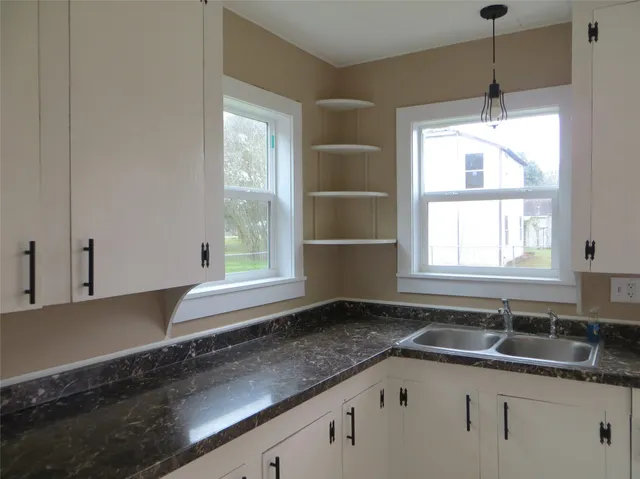 a kitchen with a sink and a window