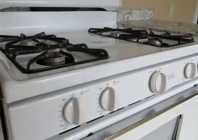 a close view of sink a stove and microwave