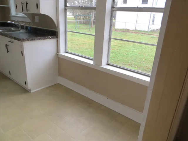 a kitchen with a sink a stove and a window