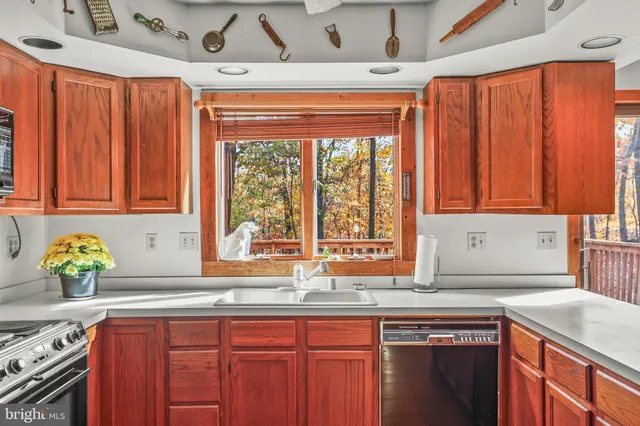 a kitchen with stainless steel appliances wooden cabinets a sink and a counter top space