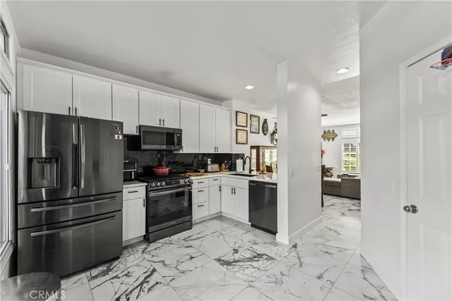 a kitchen with granite countertop a refrigerator and a sink