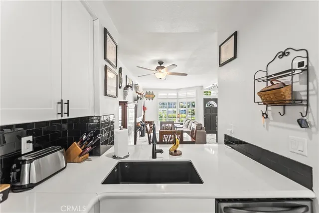 a kitchen with a sink a stove and a refrigerator