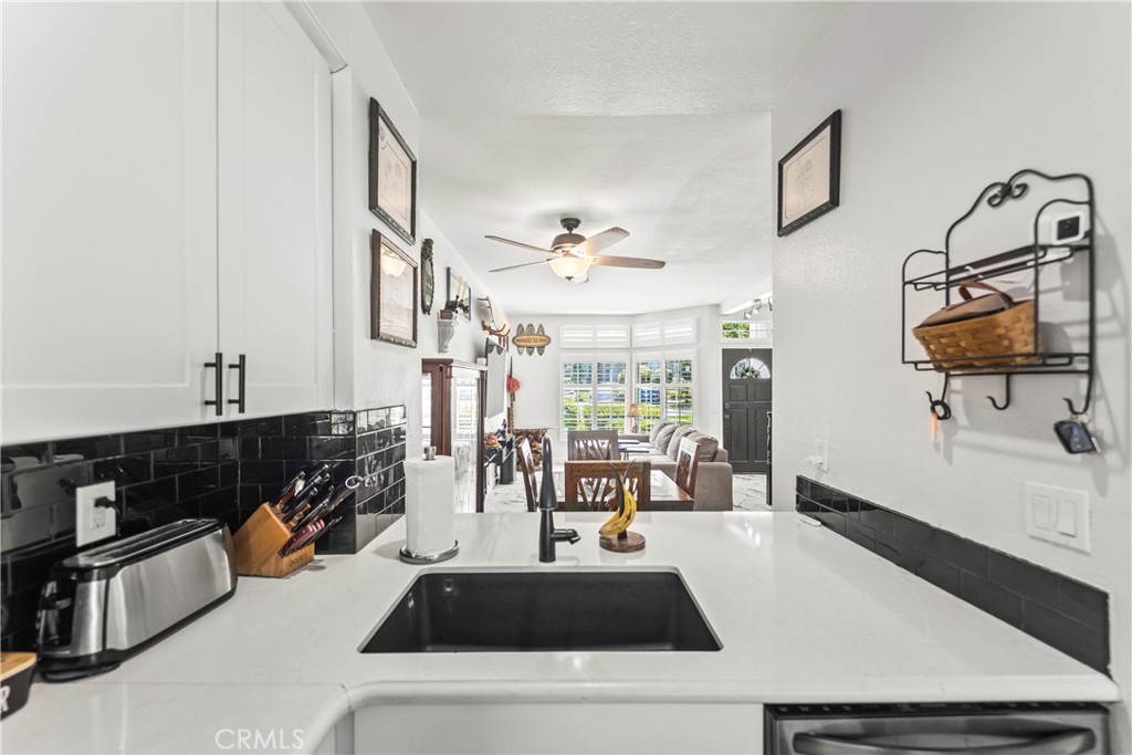 23653 Lexington Court, Unit 2 Laguna Niguel, CA 92677 - Photo 12 of 30 a kitchen with a sink a stove and a refrigerator