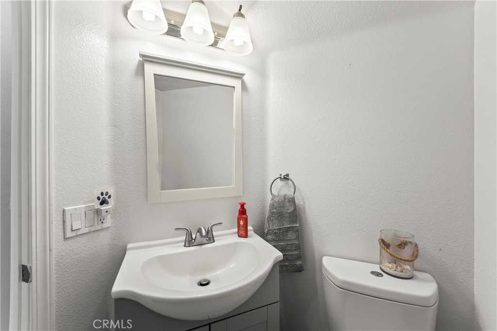 23653 Lexington Court, Unit 2 Laguna Niguel, CA 92677 - Photo 13 of 30 a bathroom with a sink a toilet and mirror