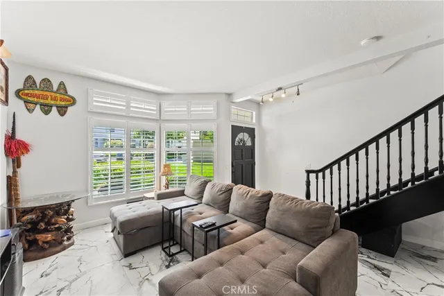 a living room with furniture and a large window