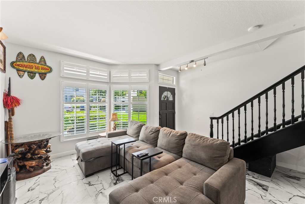 23653 Lexington Court, Unit 2 Laguna Niguel, CA 92677 - Photo 14 of 30 a living room with furniture and a large window