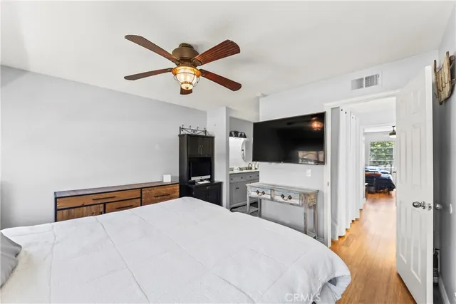 a bedroom with a bed and a flat screen tv