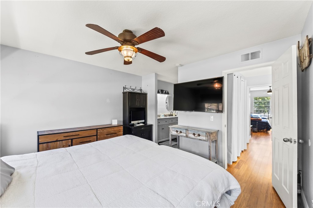 23653 Lexington Court, Unit 2 Laguna Niguel, CA 92677 - Photo 20 of 30 a bedroom with a bed and a flat screen tv