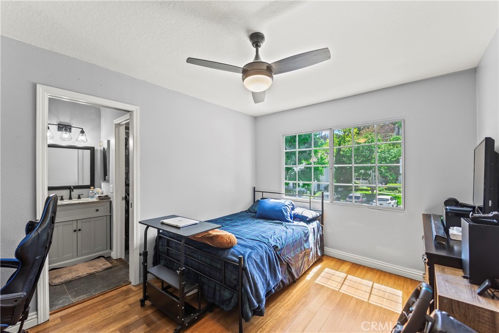 23653 Lexington Court, Unit 2 Laguna Niguel, CA 92677 - Photo 22 of 30 a bedroom with a bed and a flat screen tv