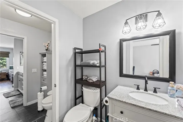 a view of a patio with a table and chairs under an umbrella