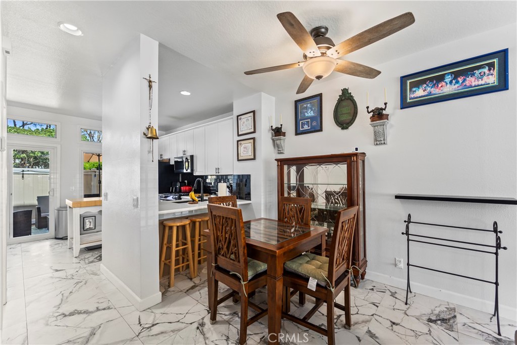 23653 Lexington Court, Unit 2 Laguna Niguel, CA 92677 - Photo 7 of 30 a view of a dining room with furniture and a clock