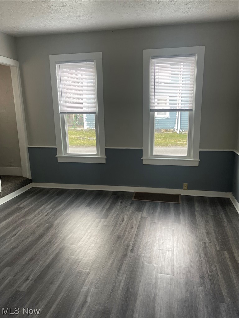 6236 Wayland Road Ravenna, OH 44266 - Photo 15 of 28 Dining room featuring wood-type flooring, a healthy amount of sunlight, and a textured ceiling