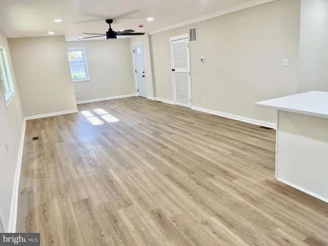 wooden floor in an empty room with a window