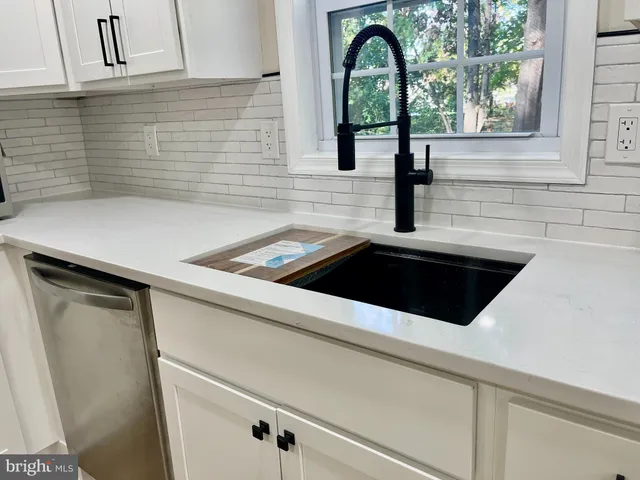 a kitchen with a sink and large window