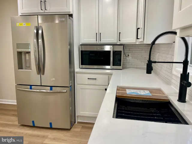 a kitchen with a refrigerator and a stove