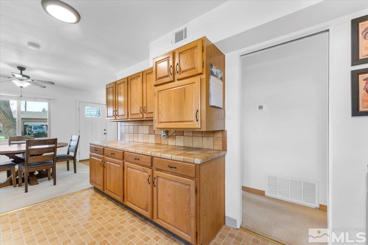 1640 Emerald Place Reno, NV 89502 - Photo 12 of 25 a bathroom with a granite countertop sink a mirror and a bathtub