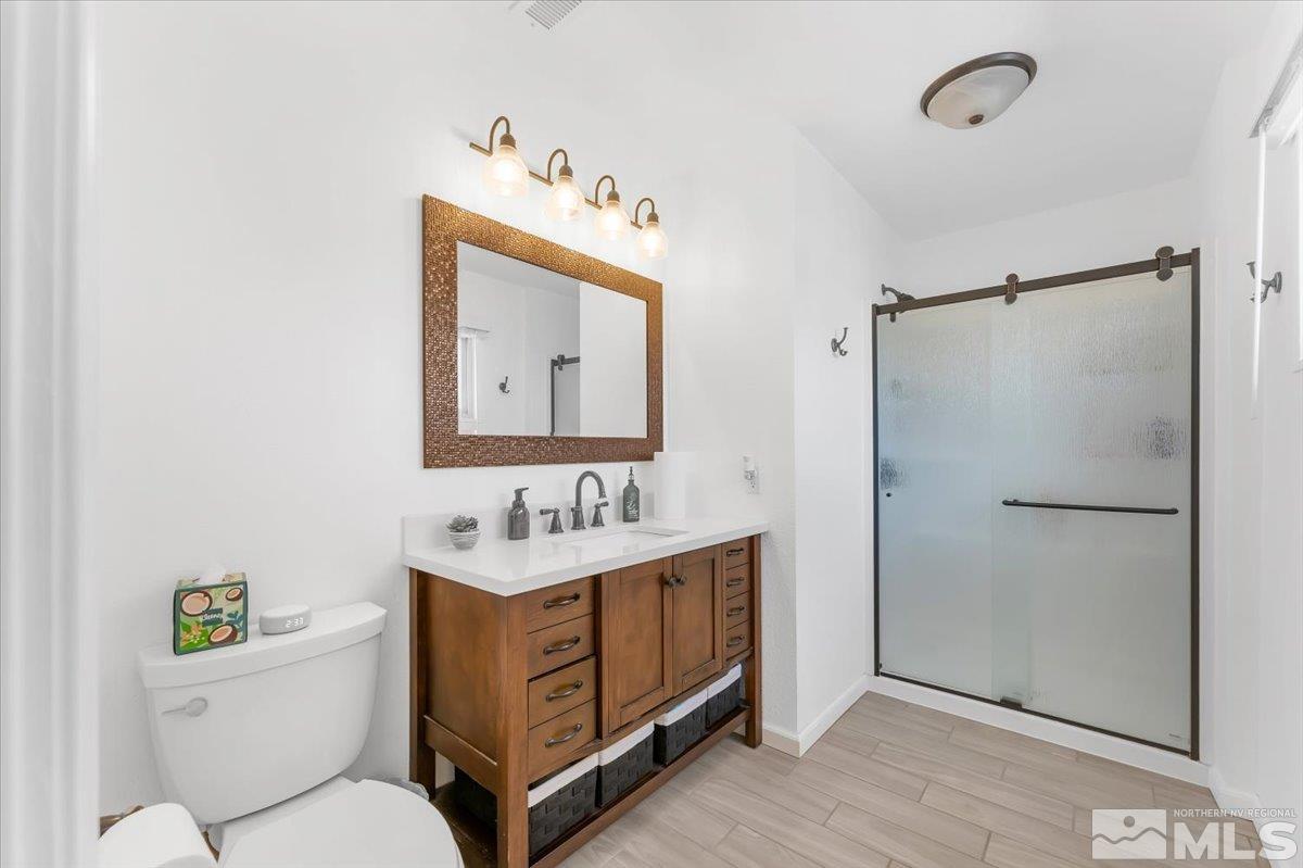 1640 Emerald Place Reno, NV 89502 - Photo 15 of 25 a bathroom with a toilet sink and mirror