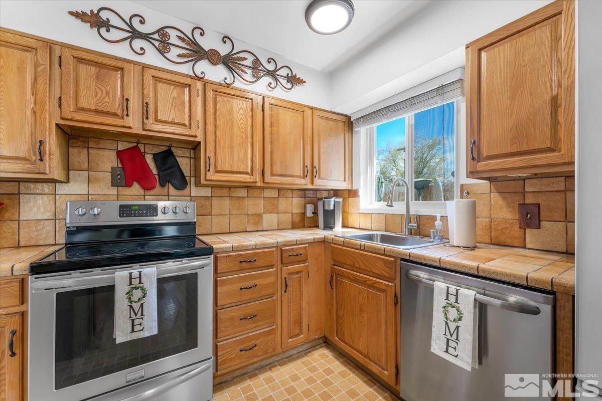 1640 Emerald Place Reno, NV 89502 - Photo 10 of 25 a kitchen with stainless steel appliances granite countertop a stove and cabinets