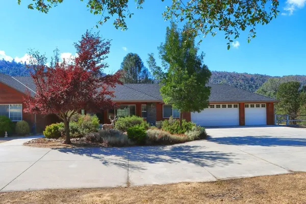 a front view of a house with a yard and a garage