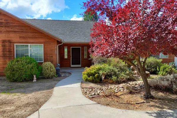 a front view of a house with a yard garage and outdoor seating