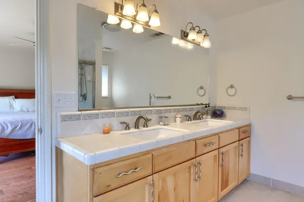 a bathroom with a sink a vanity and a mirror