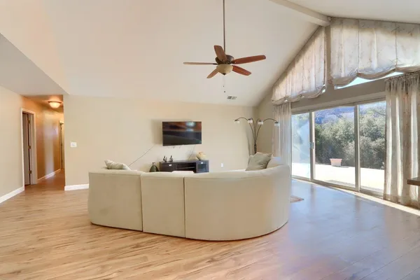 a living room with furniture and kitchen view