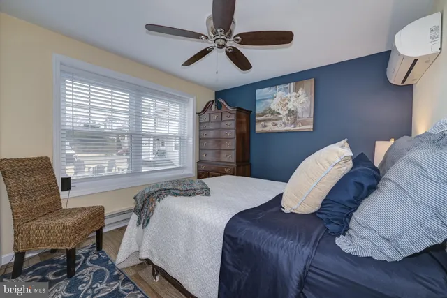a bedroom with a bed dresser and a window