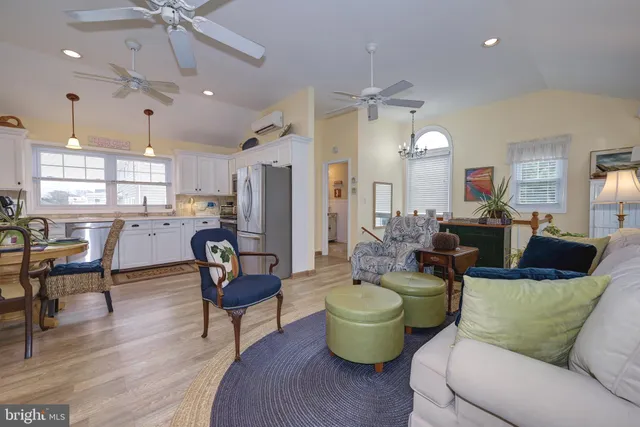 a living room with lots of furniture and a chandelier
