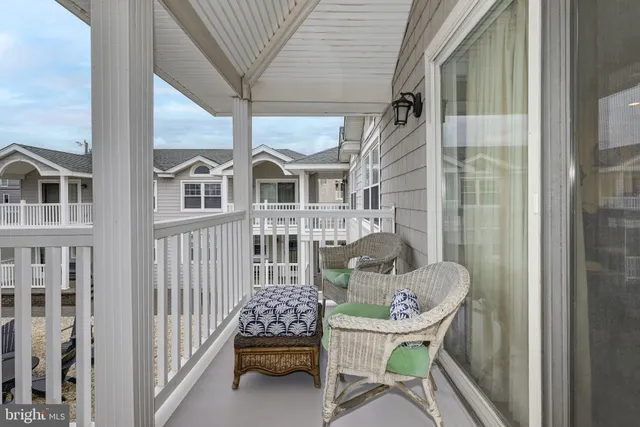 a front view of a house with outdoor seating