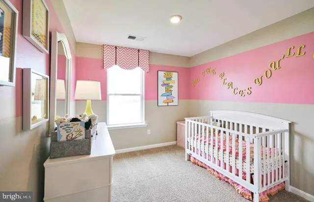 a bedroom with furniture and a large window