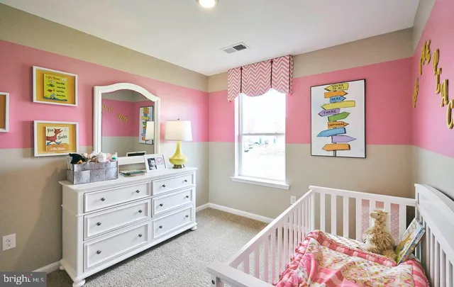 a bedroom with a bed and a dresser in it