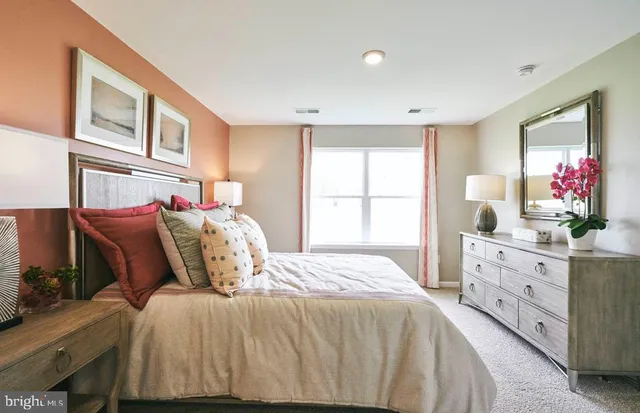 a bedroom with a bed and window