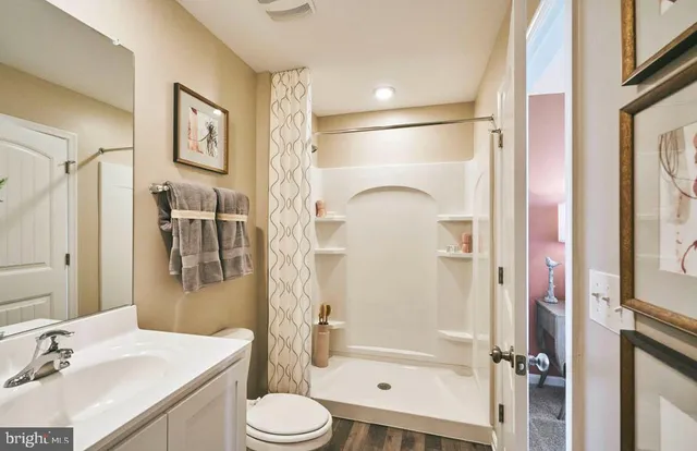 a bathroom with a sink toilet and shower