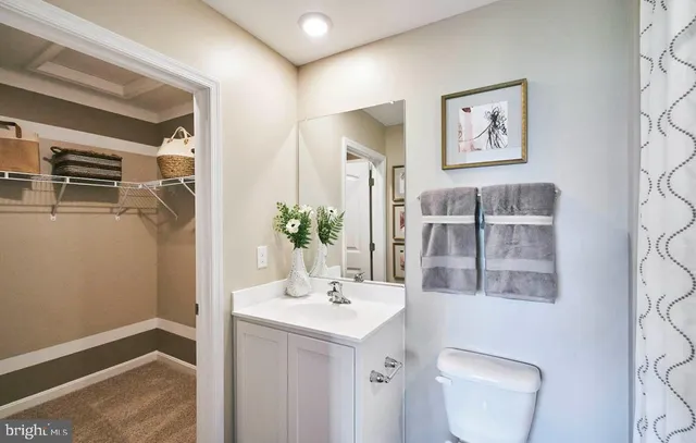 a bathroom with a toilet sink and mirror