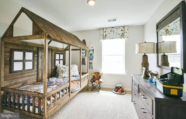 a bedroom with furniture and a large window