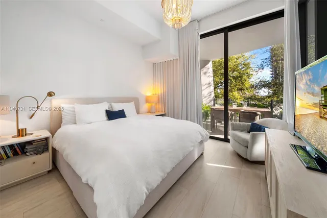 a bedroom with bed and large window